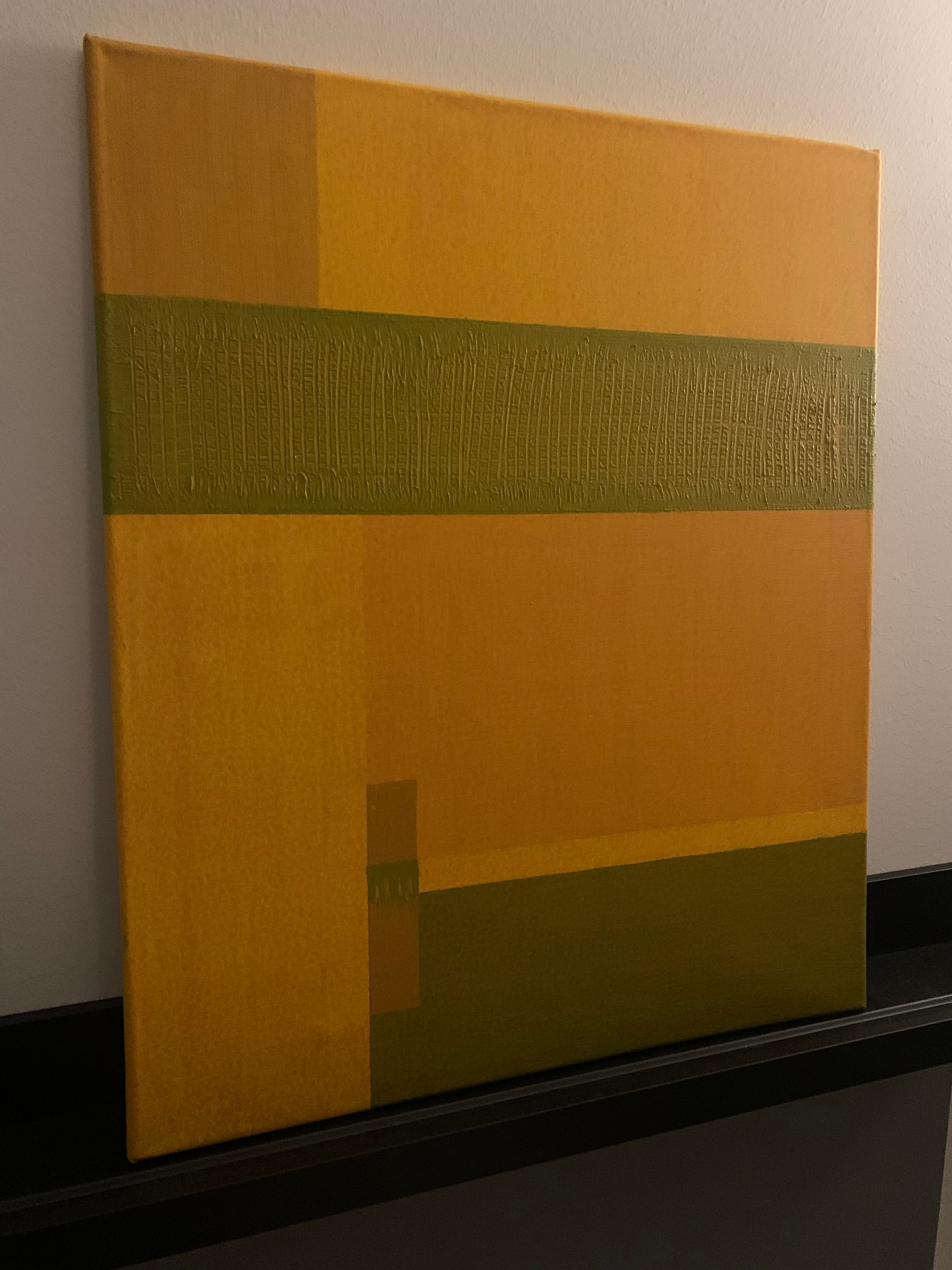 Yellow and olive canvas with a textured horizontal band and subtle geometric variations, photographed at an angle.